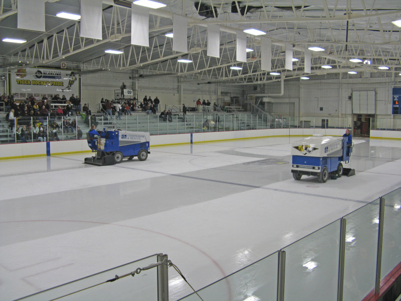 Zambonis cleaning the ice
