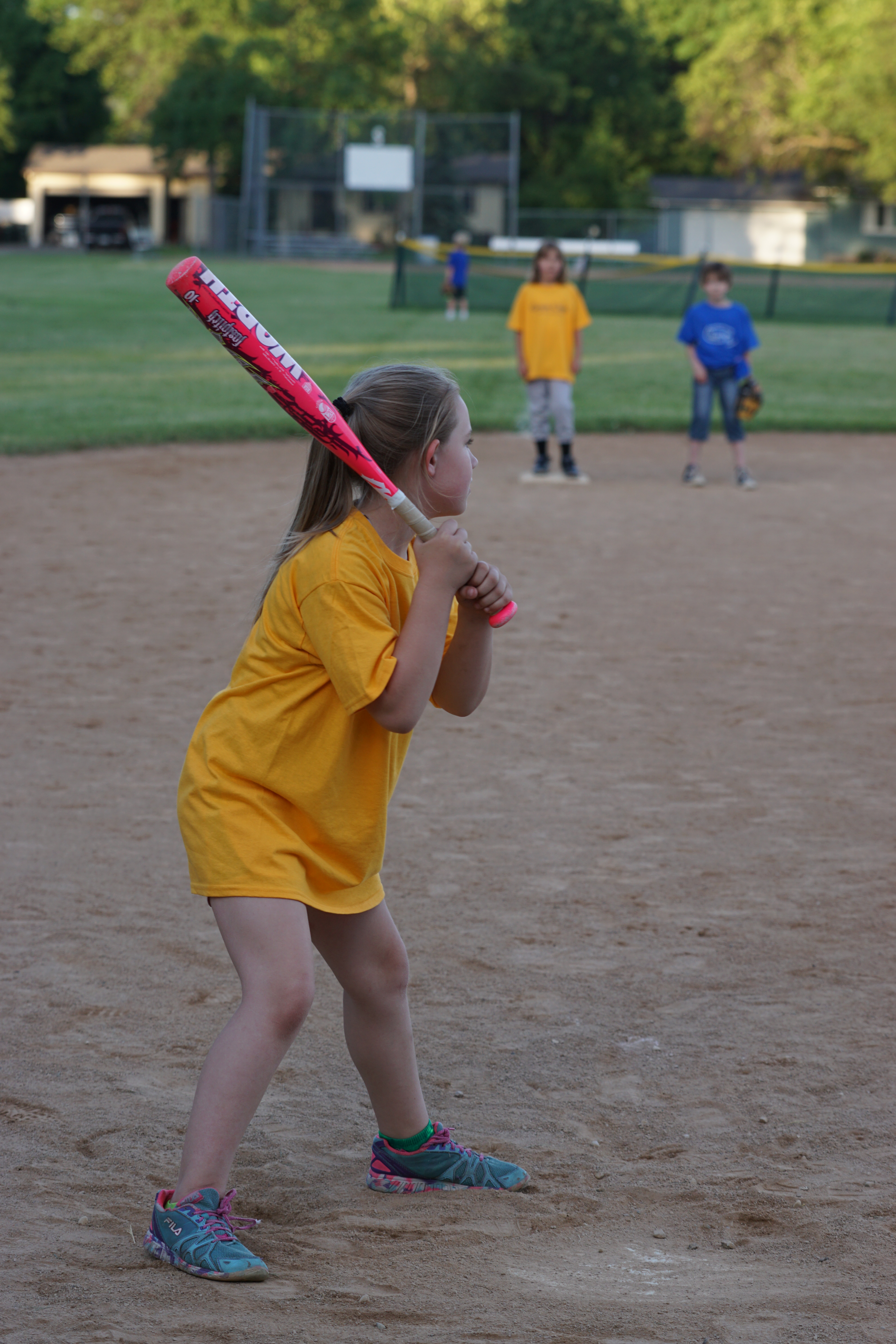 little girl playing softball