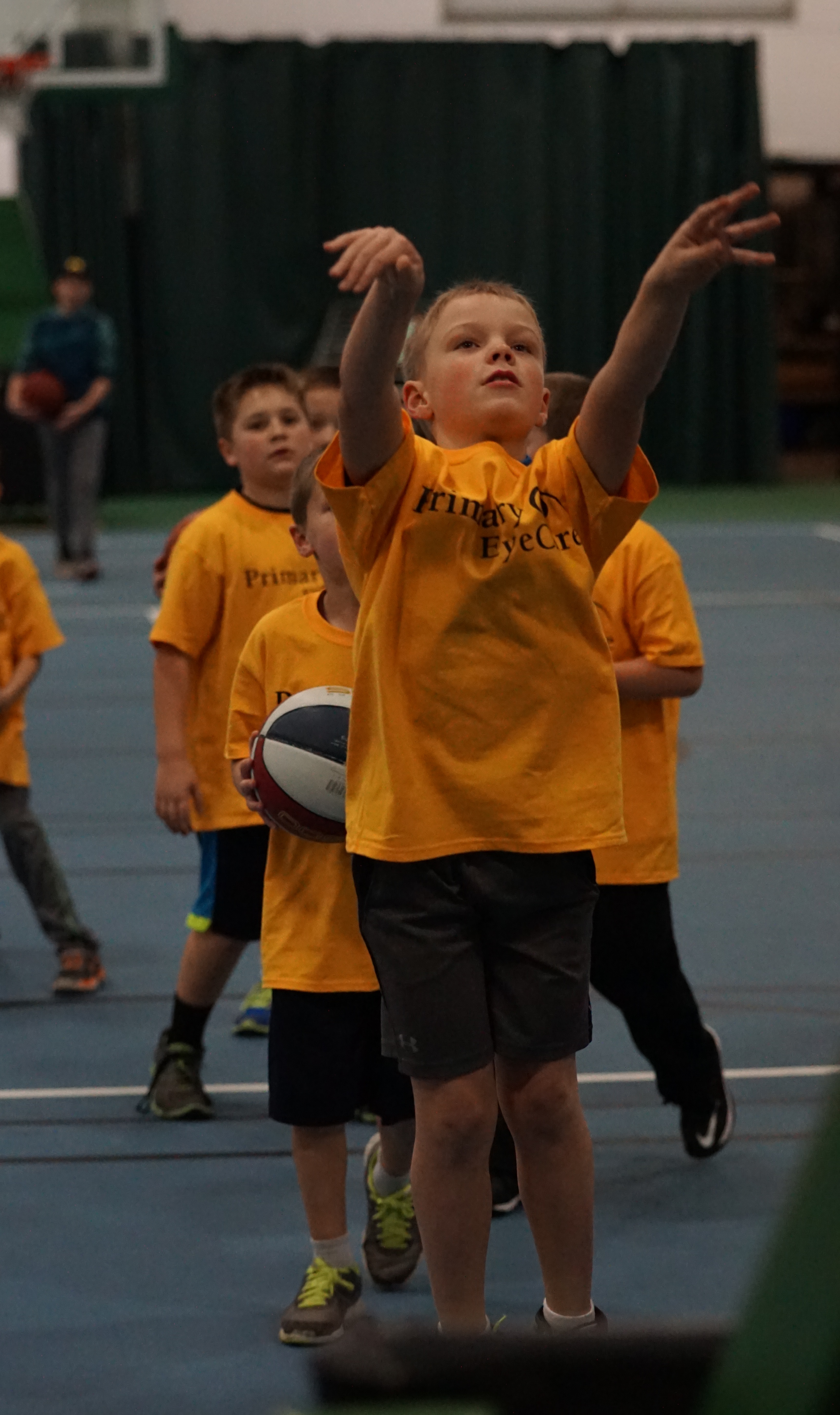 young boy shooting a basketball