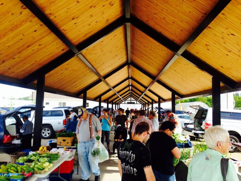 Market patrons under pavilion