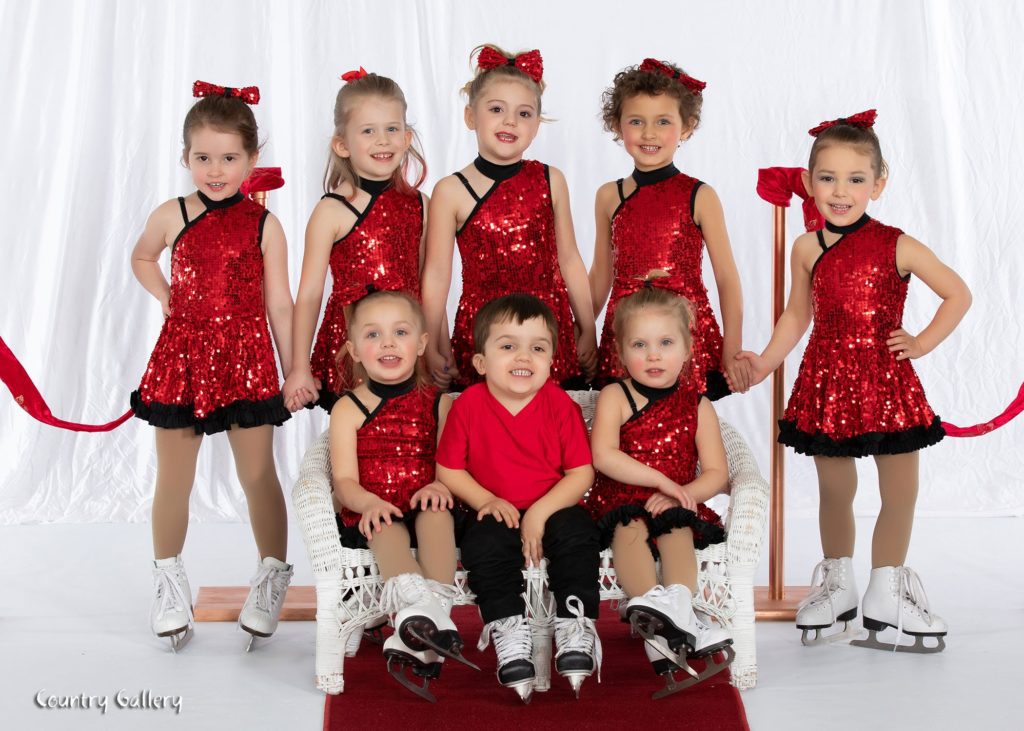 Young figure skaters in show costumes. 